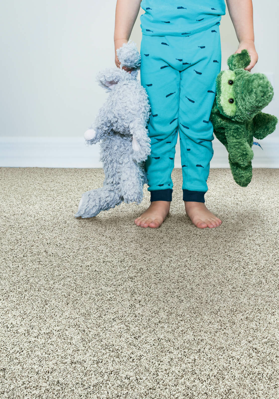 Kid with toys standing on soft carpet | T And H Floor Store