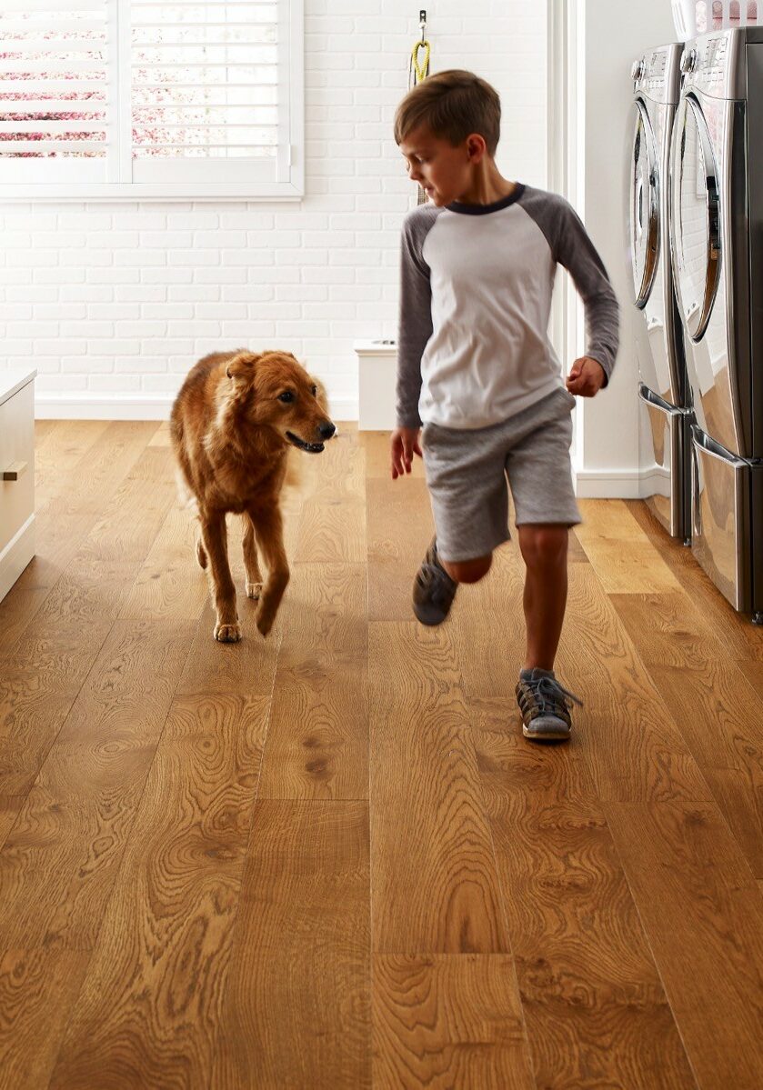 Kid running with dog | T And H Floor Store